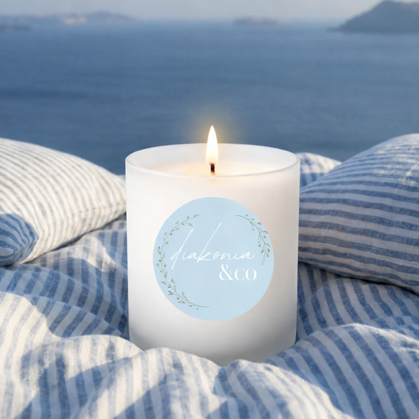 Candle with a blue label on striped fabric with a scenic background
